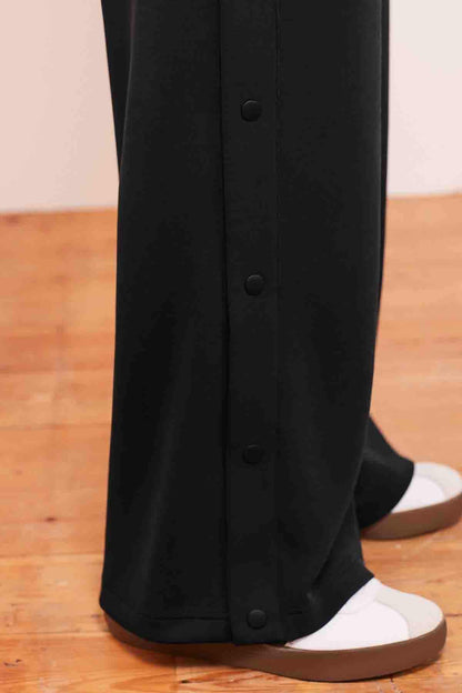 Charcoal grey wide-leg trousers with buttoned hems