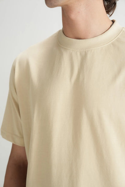 Beige short-sleeve crewneck T-shirt neckline and upper chest detail
