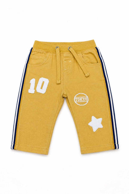 BABYSHOP yellow baby shorts with drawstring waist, side stripes, and graphic patches