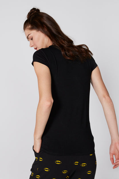Back view of black short-sleeve top with bat-printed pants in yellow