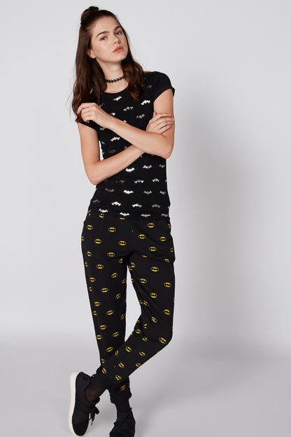 Black short-sleeve top and pants set with bat silhouettes and repeating yellow face print
