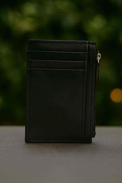 Black leather card holder back view with top zipper and stitched panels