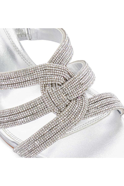 Rhinestone cross-strap and buckle detail on silver heeled sandal