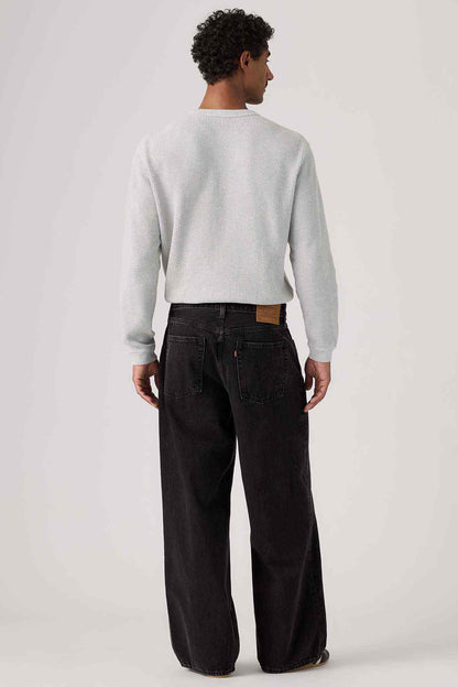 Black denim jeans back view with wide straight legs and rear yoke stitching