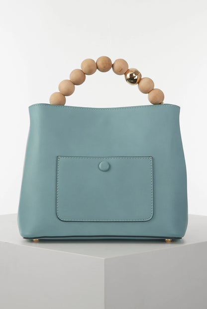 Teal handbag with wooden bead top handle and front patch pocket