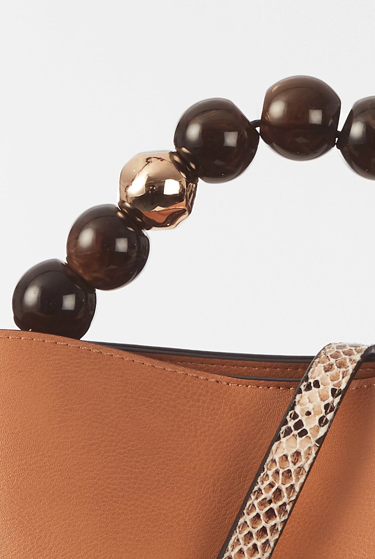 Beaded handle and leopard-print trim on brown leather bucket bag