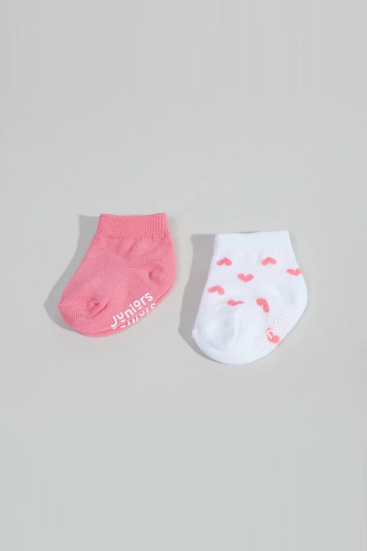 BABYSHOP baby ankle socks: one pink, one white with pink heart pattern and logo