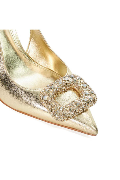 Close-up of gold metallic pointed-toe heels with rhinestone front embellishment