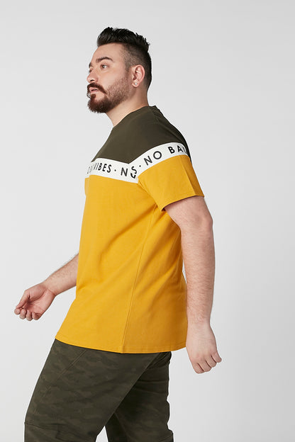 Men's colorblock T-shirt, side view; olive upper and mustard lower with logo band