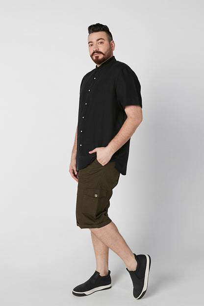 Black short-sleeve button-up shirt on model, open collar and side pockets