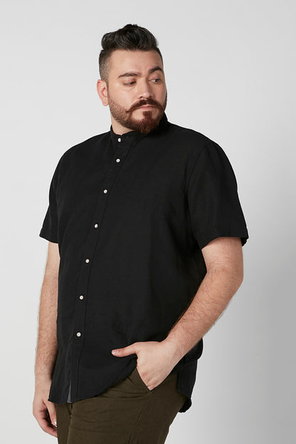 Black short-sleeve button-up shirt with button placket and relaxed fit, side hem