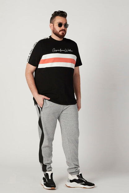 Grey sweatpants with black side stripe and drawstring, tapered fit
