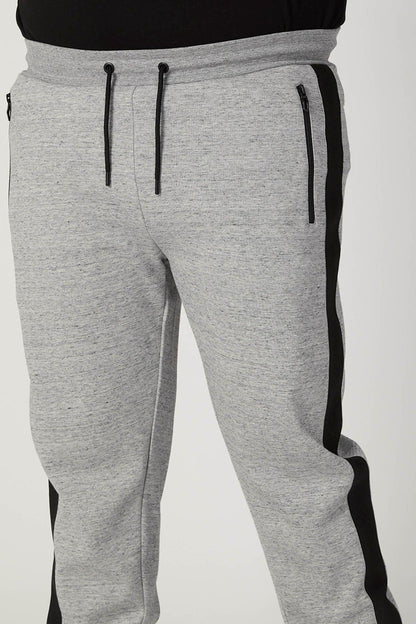Grey sweatpants with front drawstring and black side panels, tapered legs