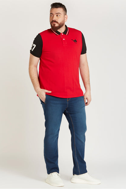 Men's red polo shirt with black sleeves, striped collar, and bird logo on chest.