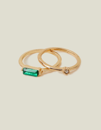 Gold-tone rings with green baguette gemstone and small crystal accents