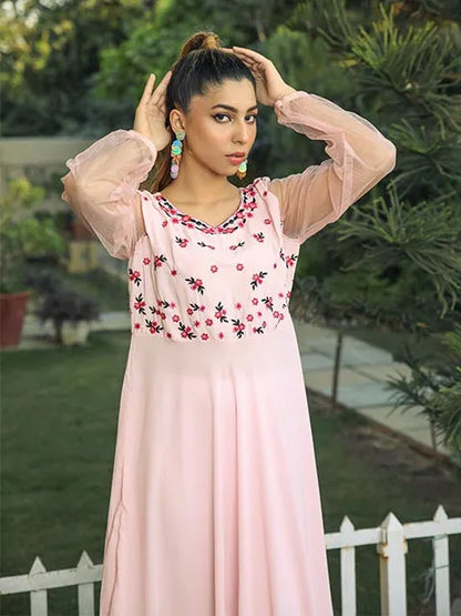 Pink floral yoke dress with sheer puff sleeves and gathered neckline.