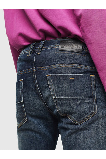 Dark wash denim jeans with back pocket label and contrast stitching
