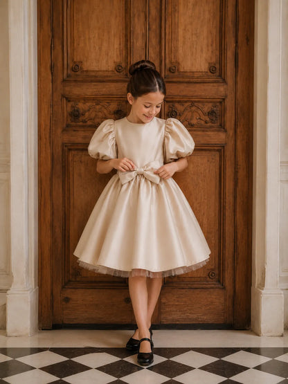 White puff-sleeve dress with satin bow at waist and flared skirt