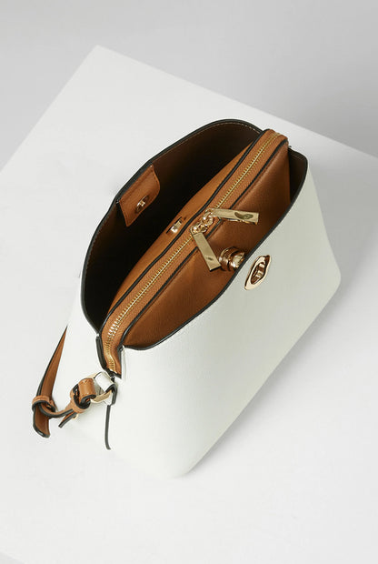 White crossbody handbag with brown interior and gold clasp hardware