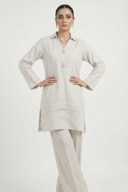 Light grey long tunic with embroidered front and scalloped lace hem, matching trousers.