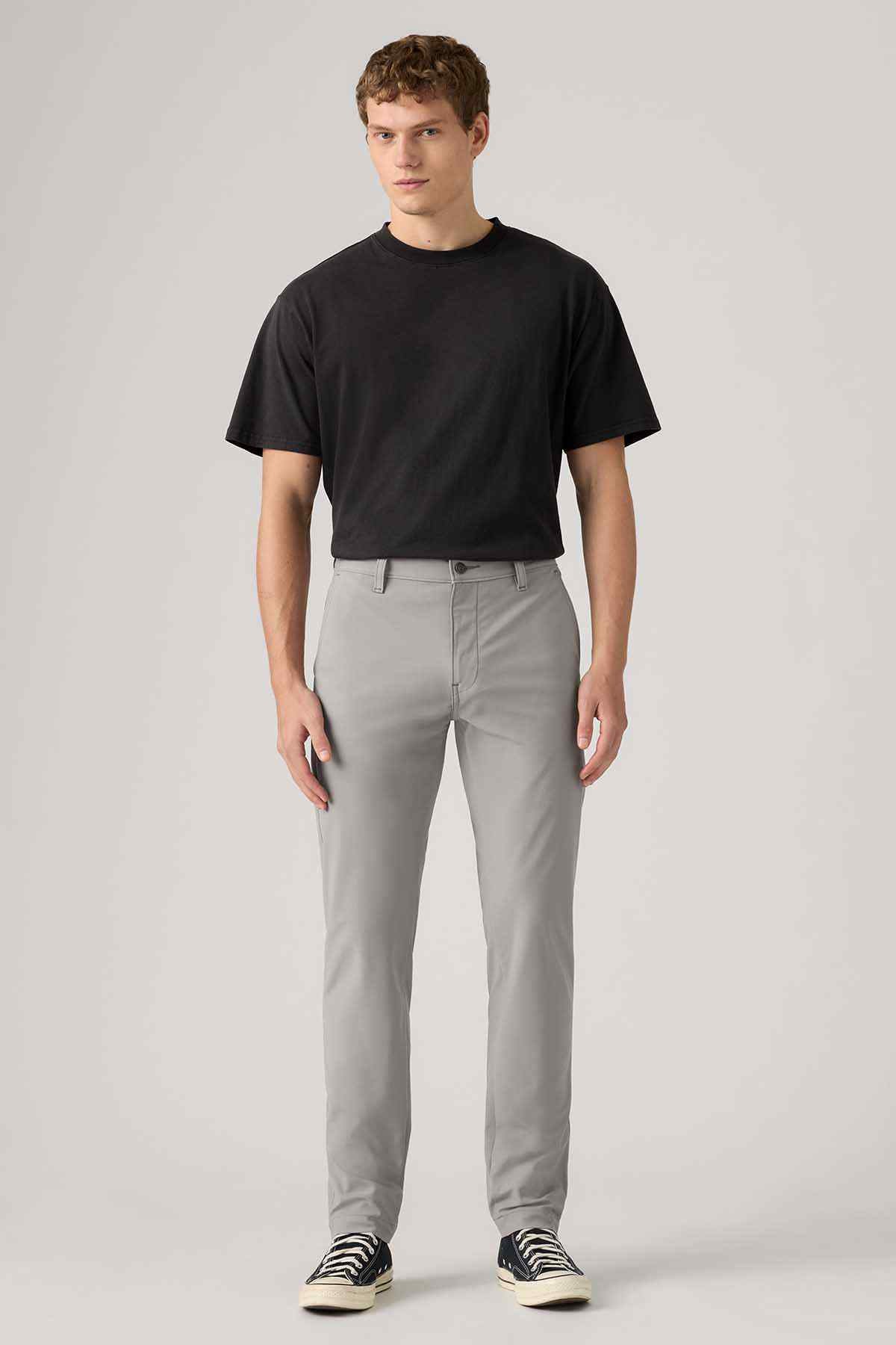 Men's grey jeans, front view with belt loops and button closure