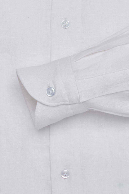 White dress shirt cuff close-up with buttoned sleeve and folded hem
