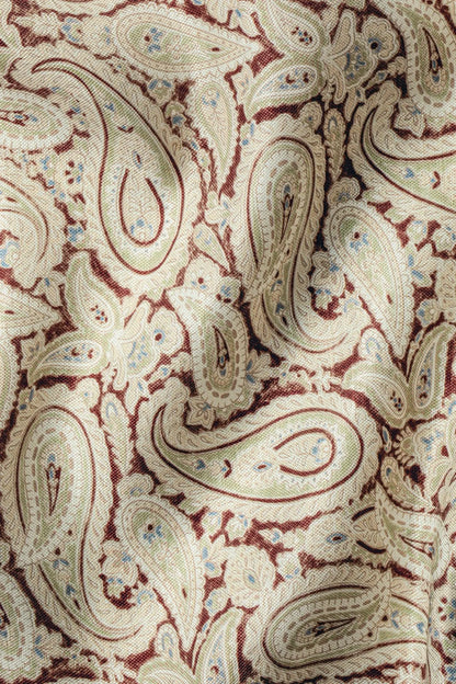Paisley pocket square close-up with cream, rust, and muted blue paisley designs