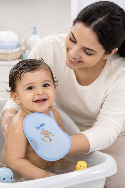 Blue baby bath wash mitt held on a baby, with bear graphic and handle