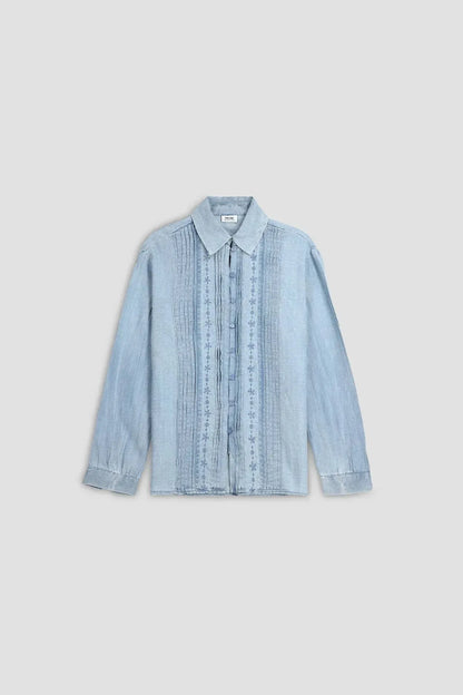 Light blue denim button-up shirt with embroidered placket and vertical stripes