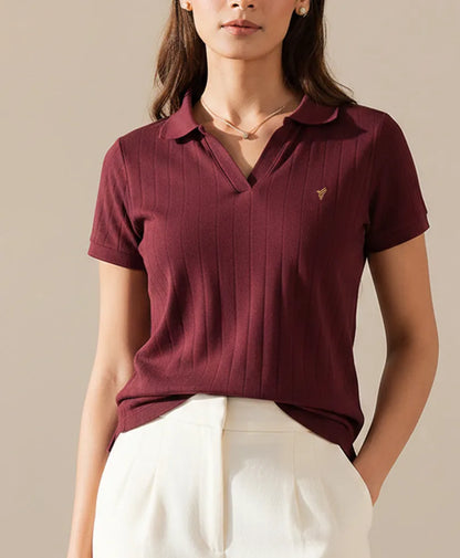 Fitted maroon knit polo shirt with short sleeves, button placket, and small chest logo