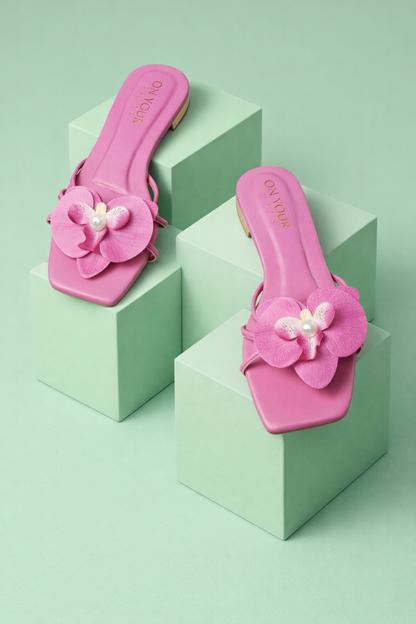 Dark pink slide sandals with three-petal flower embellishment and pearl bead accents