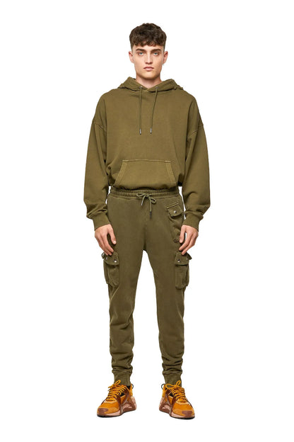 Olive cargo jogger pants on model, drawstring waist and utility pockets