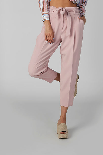 Pink cropped trousers with bow-tie waist and pleated front, cuffed hem