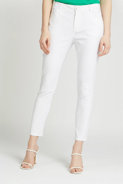 White ankle-length tapered pants with front button-and-zip closure