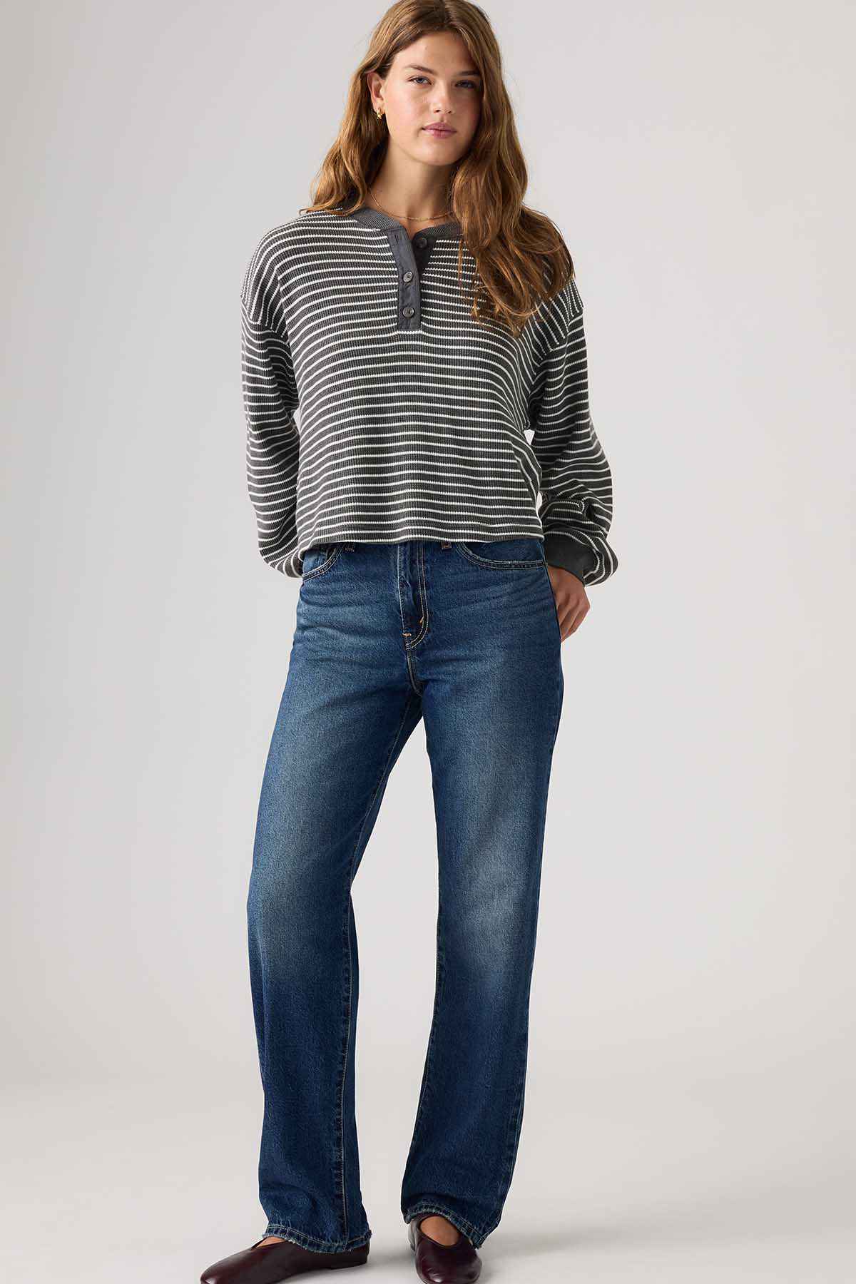 Dark indigo slightly flared jeans with belt loops and zip fly