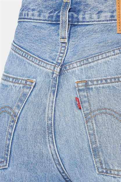Levi's light-wash denim jeans close-up of front pockets, belt loops, and button closure.