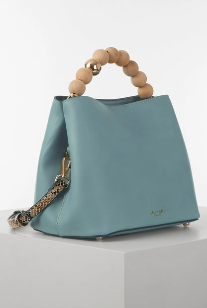 Teal tote-style handbag with wooden bead handle and gold zipper hardware