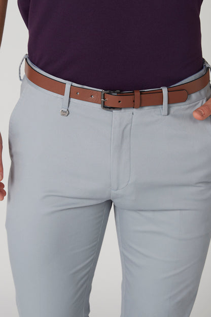 Light blue trousers with brown leather belt and metal buckle, close-up