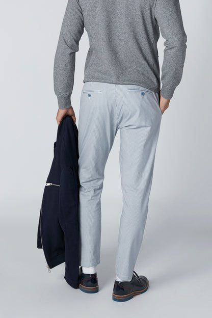 Men's heather gray long-sleeve top with light blue trousers, belt loops