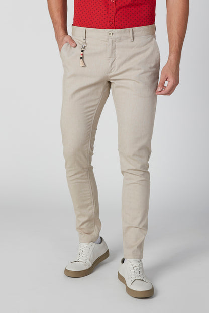 Beige men's slim-fit pants with front pockets and zip fly, ankle-length