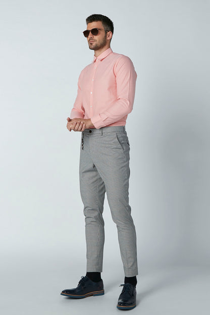 Men's gray checkered pants with tapered legs and button-zip fly, styled with sneakers