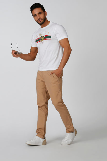 Men's brown chino pants with cuffed hems and belt loops, worn with sneakers