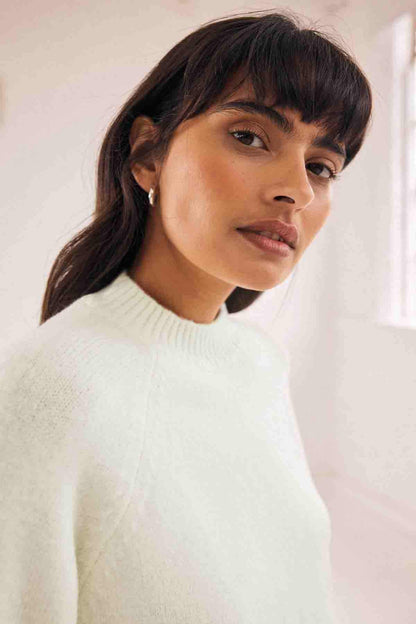 Ecru knit sweater with ribbed high neck
