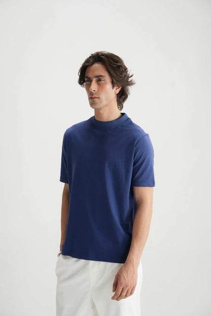 Blue crew-neck short-sleeve T-shirt worn with white pants