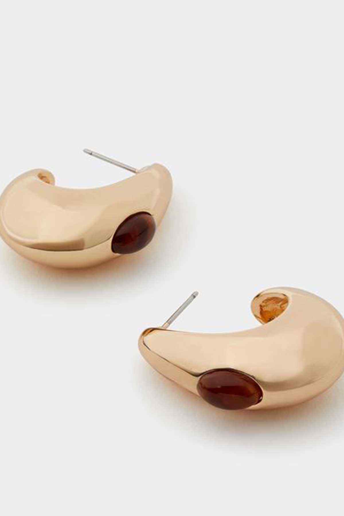 Brown teardrop earrings with beige curved setting and dark amber center