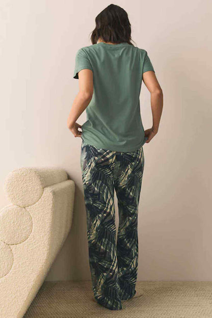 NEXT green V-neck short-sleeve top, back view, leaf-print wide-leg pants
