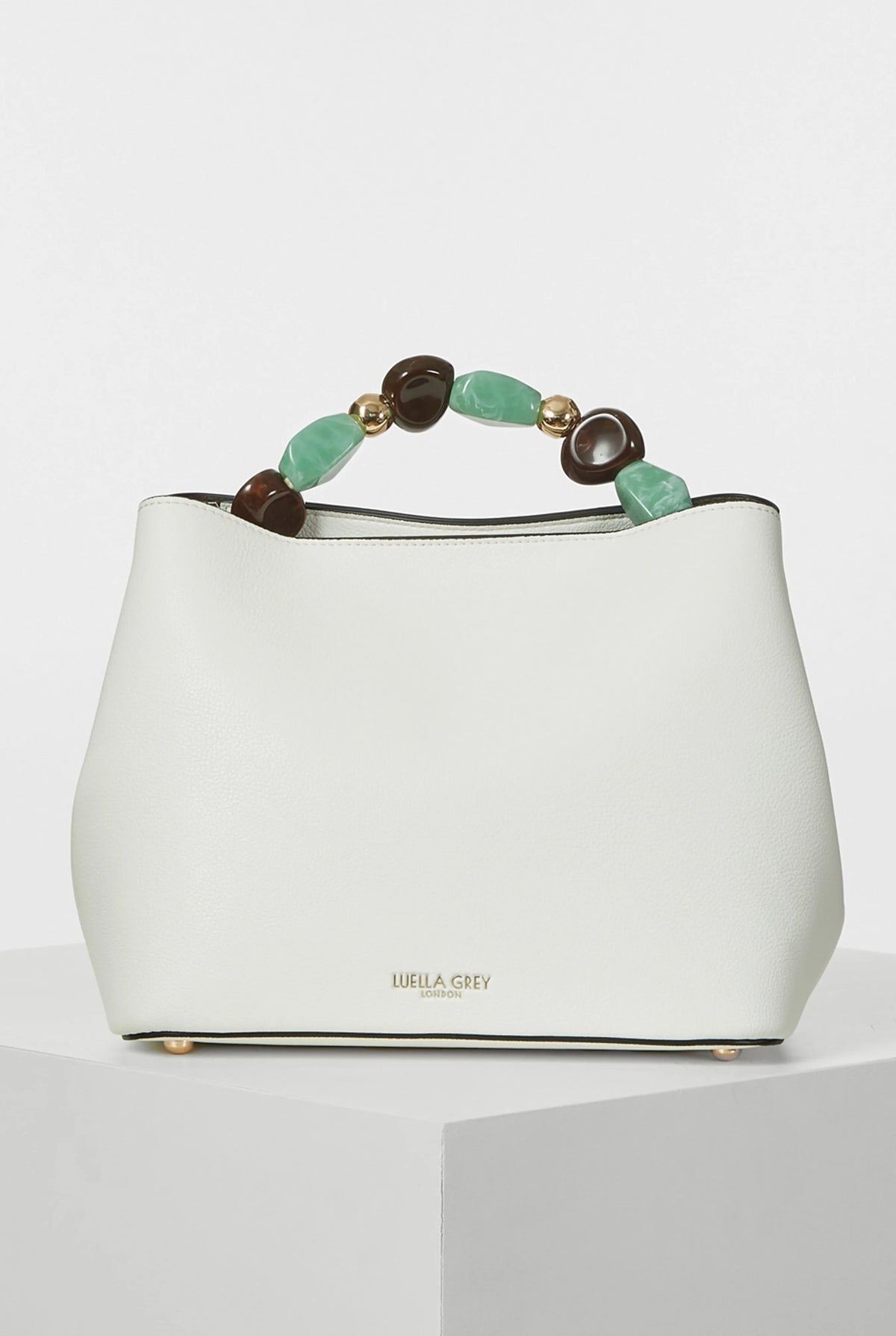 White handbag with beaded top handle in green and brown, gold-tone feet