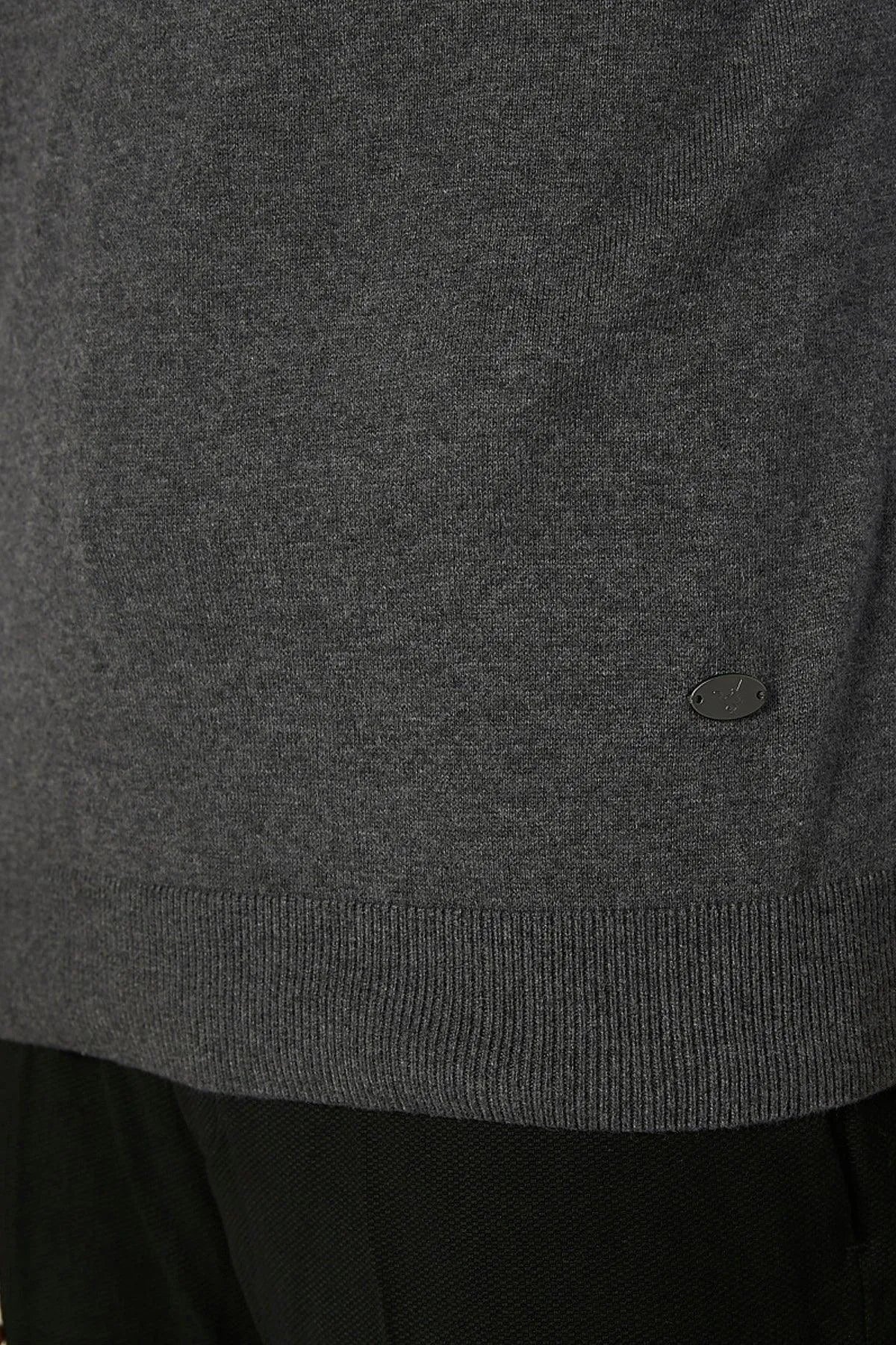 Grey knit sweater vest hem with small oval logo detail