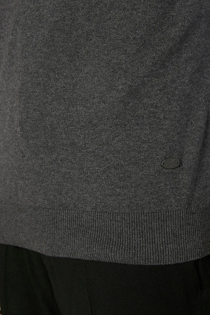 Grey knit sweater vest hem with small oval logo detail