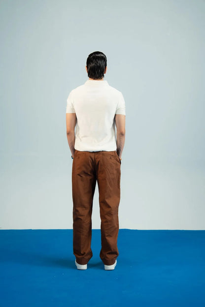 Brackets polo shirt and trousers: back view of white polo and brown trousers